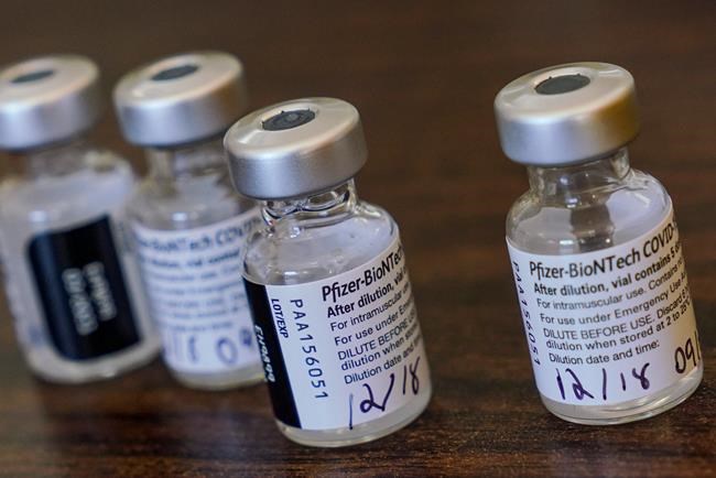 Vials of the Pfizer-BioNTech vaccine are pictured on a table as nurses prepared to vaccinate residents and staff at Gulf Shore Care Center, Friday, Dec. 18, 2020 in Pinellas Park, Fla. (Martha Asencio Rhine/Tampa Bay Times via AP)