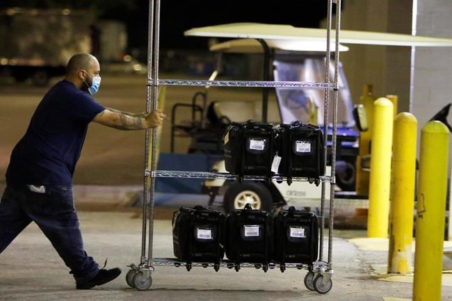 Staff at the Hillsborough County Supervisor of Elections receive and count ballots late into the night in Tampa, Fla., Tuesday, Nov. 3, 2020. (Luis Santana/Tampa Bay Times via AP)