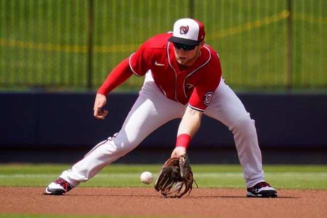 Washington Nationals third baseman Carter Kieboom fields a ground ball by Houston Astros' Carlos Correa during the first inning of a spring training baseball game Monday, March 1, 2021, in West Palm Beach, Fla. (AP Photo/Jeff Roberson)