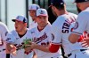 Washington Nationals' JB Shuck, center, is handed a cabbage by teammate Javy Guerra, left, before handing it to Hunter Strickland, right, as part of a team building exercise during spring training baseball practice Monday, Feb. 17, 2020, in West Palm Beach, Fla. The event was also held to mark National Cabbage Day. (AP Photo/Jeff Roberson)