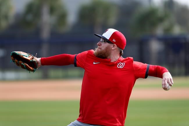 Washington Nationals pitcher Sean Doolittle throws during spring training baseball practice Friday, Feb. 14, 2020, in Jupiter, Fla. (AP Photo/Jeff Roberson)