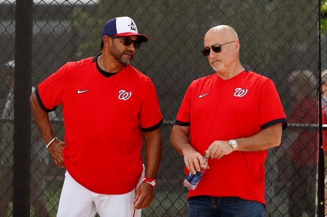Washington Nationals manager Dave Martinez, left, talks with general manager Mike Rizzo during spring training baseball practice Monday, Feb. 17, 2020, in West Palm Beach, Fla. (AP Photo/Jeff Roberson)