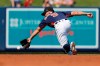 Houston Astros shortstop Jack Mayfield dives for a ground ball single by New York Mets' Michael Conforto during the third inning of a spring training baseball game Saturday, Feb. 29, 2020, in West Palm Beach, Fla. (AP Photo/Jeff Roberson)