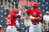 Washington Nationals' Ryan Zimmerman, right, is congratulated by teammate Yadiel Hernandez after hitting a solo home run during the third inning of a spring training baseball game against the Houston Astros Monday, March 1, 2021, in West Palm Beach, Fla. (AP Photo/Jeff Roberson)