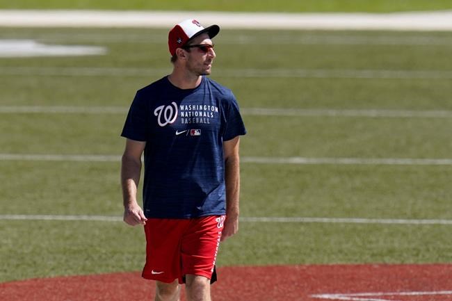 Washington Nationals pitcher Max Scherzer walks back to the clubhouse after spring training baseball practice Thursday, Feb. 25, 2021, in West Palm Beach, Fla. (AP Photo/Jeff Roberson)