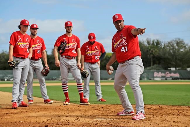 St. Louis Cardinals pitchers listen as coach Dernier Orozco (41) instructs them on covering home plate during spring training baseball practice Sunday, Feb. 16, 2020, in Jupiter, Fla. (AP Photo/Jeff Roberson)