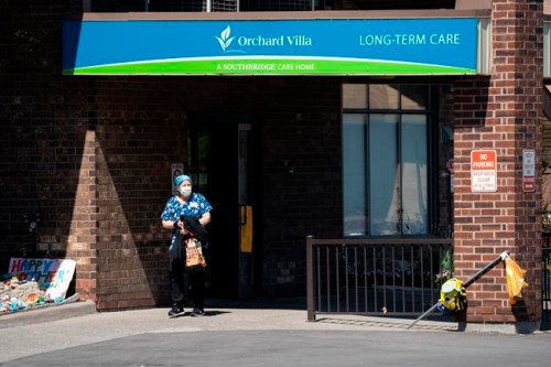 A home-care worker is shown outside Orchard Villa long-term care home in Pickering, Ont., on Tuesday, May 26, 2020. THE CANADIAN PRESS/Frank Gunn