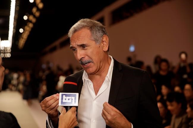 FILE - In this Thursday, Sept. 20, 2018 file photo, Carlo Capasa, head of the National Chamber of Italian Fashion, attends the Fendi women's 2019 Spring-Summer fashion show, during the Fashion Week in Milan, Italy. Italy’s fashion chamber opens the first Milan Fashion Week on Friday with no VIPS populating runway front rows, as the reality of the persistent virus resurgence in Italy has forced an all-digital, no physical week of menswear previews. (AP Photo/Luca Bruno, File)