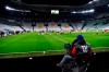 FILE - In this Sunday, March 8, 2020. filer, players warm up in the empty Allianz stadium, prior to the Serie A soccer match between Juventus and Inter Milan, in Turin, Italy. The Italian soccer players' association rejected a proposal from Serie A clubs Monday to reduce salaries by a third if the season does not resume as 