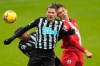 Newcastle's Fabian Schaer and Southampton's Jannik Vestergaard, right, vie for the ball during the English Premier League soccer match between Newcastle and Southampton, at St. James' Park Stadium in Newcastle, England, Saturday, Feb. 6, 2021. (Owen Humphreys, Pool via AP)