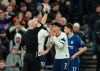 Referee Anthony Taylor shows a red card to Tottenham's Son Heung-min during the English Premier League soccer match between Tottenham Hotspur and Chelsea, at the Tottenham Hotspur Stadium in London, Sunday, Dec. 22, 2019. (AP Photo/Ian Walton)