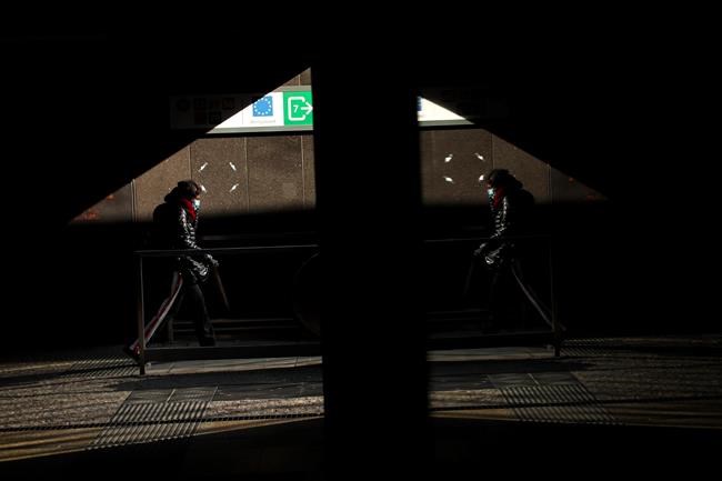 A woman wearing a protective mask steps out Schuman metro station near the EU headquarters in Brussels, Wednesday, March 18, 2020. Belgium has ordered further lockdown measures starting Wednesday, following in the steps of European neighbours Italy, Spain and France. For most people, the new coronavirus causes only mild or moderate symptoms, such as fever and cough. For some, especially older adults and people with existing health problems, it can cause more severe illness, including pneumonia. (AP Photo/Francisco Seco)