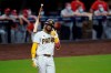 FILE - In this Oct. 1, 2020, file photo, San Diego Padres' Fernando Tatis Jr. tosses his bat after hitting a two-run home run during the seventh inning of Game 2 of the team's National League wild-card baseball series against the St. Louis Cardinals in San Diego. Tatis Jr. has yet to take a ground ball or swing a bat at spring training and he i already the talk of the Padres’ clubhouse. The electrifying shortstop and the Padres have agreed to a $340 million, 14-year deal, giving San Diego’s camp even more buzz than it already had after the team made a number of high-profile offseason moves. (AP Photo/Gregory Bull, File)
