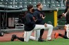 San Francisco Giants' Jaylin Davis, left, and Austin Slater kneel with others during the national anthem before an exhibition baseball game against the Oakland Athletics in San Francisco, Tuesday, July 21, 2020. (AP Photo/Jeff Chiu)
