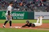 San Francisco Giants' Buster Posey, right, slides safely into third base next to Miami Marlins third baseman Jon Berti during the fifth inning of a baseball game in San Francisco, Saturday, April 24, 2021. (AP Photo/Jeff Chiu)