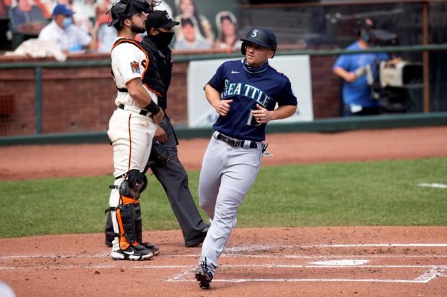Seattle Mariners' Kyle Seager (15) scores on an RBI single by Tim Lopes during the second inning of a baseball game against the San Francisco Giants, Thursday, Sept. 17, 2020 in San Francisco. (AP Photo/D. Ross Cameron)