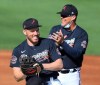 Atlanta Braves first baseman Freddie Freeman, foreground, shares a laugh with Chipper Jones during a baseball spring training practice before a game against the Minnesota Twins in North Port, Fla., Friday, March 5, 2021. (Curtis Compton/Atlanta Journal-Constitution via AP)