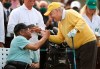 Honorary starter Lee Elder, left, shakes hands with six-time Masters champion Jack Nicklaus during the ceremonial tee shots to begin the Masters golf tournament at Augusta National Golf Club in Augusta, Ga., Thursday, April 8, 2021. (Curtis Compton/Atlanta Journal-Constitution via AP)