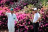 Caddy Adam Hayes, left, gestures beside Jon Rahm, right, as Rahm prepares to putt on the 13th hole during a practice round for the Masters golf tournament in Augusta, Ga., Wednesday, April 7, 2021. (Curtis Compton/Atlanta Journal-Constitution via AP)