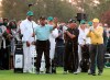 Honorary starter Lee Elder, left, gestures as he is introduced and applauded by honorary starters Gary Player and Jack Nicklaus, right, before the ceremonial tee shots to begin the Masters golf tournament at Augusta National Golf Club in Augusta, Ga., Thursday, April 8, 2021. (Curtis Compton/Atlanta Journal-Constitution via AP)