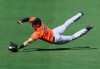 Baltimore Orioles outfielder Austin Hays can't quite get to a ball hit for an RBI single by Atlanta Braves Adam Duvall during the first inning in a MLB spring training baseball game Saturday, Feb. 22, 2020, in North Port, Fla. (Curtis Compton/Atlanta Journal-Constitution via AP)