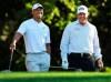 FILE - In this April 3, 2018, file photo, Tiger Woods, left, and Phil Mickelson share a laugh on the 11th tee box while playing a practice round for the Masters golf tournament at Augusta National Golf Club in Augusta, Ga. The next match involving Tiger Woods and Phil Mickelson involves a $10 million donation for COVID-19 relief efforts, along with plenty of bragging rights in a star-powered foursome May 24 at Medalist Golf Club. Turner Sports announced more details Thursday, May 7, 2020, for “The Match: Champions for Charity,” a televised match between Woods and Peyton Manning against Mickelson and Tom Brady. (Curtis Compton/Atlanta Journal-Constitution via AP, File)