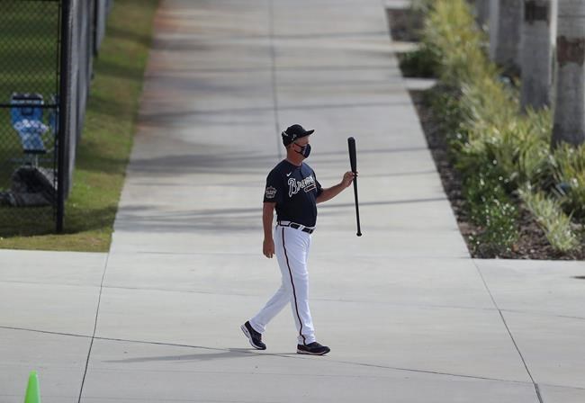 Atlanta Braves Hall of Famer Chipper Jones leaves the batting cages twirling his bat after a morning session of batting practice during baseball spring training, Wednesday, Feb. 24, 2021, in North Port, Fla. (Curtis Compton/Atlanta Journal-Constitution via AP)