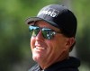 Phil Mickelson is all smiles sharing a laugh with the patrons while he tees off on the 14th hole during his practice round for the Masters at Augusta National Golf Club on Tuesday, April 6, 2021, in Augusta, Ga. (Curtis Compton/Atlanta Journal-Constitution via AP)