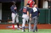 Atlanta Braves left fielder Adam Duvall (23) leaves the game after getting injured on a swing as shortstop Dansby Swanson, left, taps him with his bat against the Los Angeles Dodgers during the second inning in Game 1 Monday, Oct. 12, 2020, for the best-of-seven National League Championship Series at Globe Life Field in Arlington, Texas. Duvall had to leave the game. (Curtis Compton/Atlanta Journal-Constitution via AP)