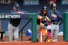 Atlanta Braves manager Brian Snitker, left, and right fielder Ronald Acuna watch after the Braves ended a scoring opportunity scoring no runs during the second inning against the Los Angeles Dodgers in Game 6 of baseball’s National League Championship Series, Saturday, Oct. 17, 2020, in Arlington, Texas. (Curtis Compton/Atlanta Journal-Constitution via AP)