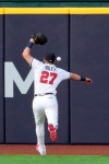 Atlanta Braves left fielder Austin Riley misses a double hit by Los Angeles Dodgers first baseman Max Muncy during the third inning in Game 3 of a baseball National League Championship Series Wednesday, Oct. 14, 2020, in Arlington, Texas. (Curtis Compton/Atlanta Journal-Constitution via AP)