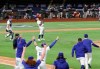 The Atlanta Braves dugout looks on as the Los Angeles Dodgers begin to celebrate their 4-3 victory in Game 7 of a baseball National League Championship Series, Sunday, Oct. 18, 2020, in Arlington, Texas. (Curtis Compton/Atlanta Journal-Constitution via AP)