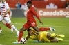 United States goalkeeper Zack Steffen (1) watches through the legs of Canada forward Jonathan David (20) as he lines up a shot on net during first half of CONCACAF Nations League soccer action in Toronto, Tuesday, Oct. 15, 2019. THE CANADIAN PRESS/Cole Burston