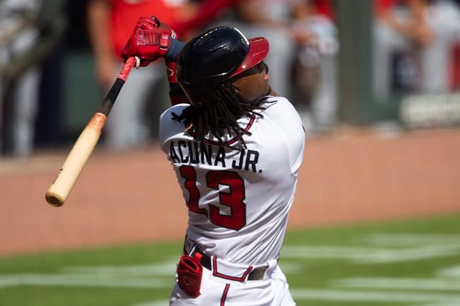 Atlanta Braves' Ronald Acuna Jr. follows through on a solo home run to center field during the first inning of a doubleheader baseball game against the Washington Nationals, Friday, Sept. 4, 2020, in Atlanta. (AP Photo/John Amis)