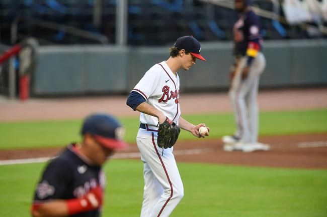 Atlanta Braves' Max Fried, center, walks back to the mound as Washington Nationals' Asdrubal Cabrera takes first base and Victor Robles stands on third base during the first inning inning of a baseball game Saturday, Sept. 5, 2020, in Atlanta. (AP Photo/John Amis)