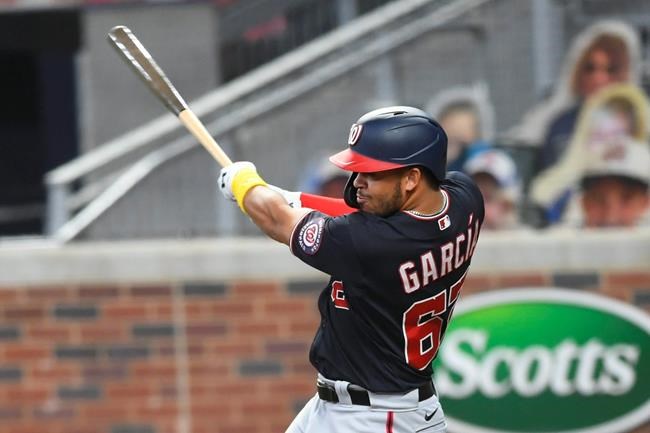 Washington Nationals' Luis Garcia hits a one-run single to second base during the sixth inning of a baseball game against the Atlanta Braves, Saturday, Sept. 5, 2020, in Atlanta. (AP Photo/John Amis)