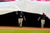 Members of the Atlanta Braves grounds crew cover the field ahead of a rain shower before the start of a baseball game between the Atlanta Braves and the Washington Nationals Wednesday, Aug. 19, 2020, in Atlanta. (AP Photo/John Bazemore)