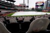 A tarp covers the infield at Truist Park as a sign announces that the baseball game between the New York Yankees and the Atlanta Braves has been postponed because of inclement weather, Tuesday, Aug. 25, 2020, in Atlanta. (AP Photo/John Bazemore)