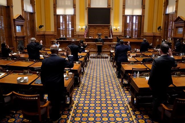 Members of Georgia's Electoral College are sworn in before casting their votes at the state Capitol, Monday, Dec. 14, 2020, in Atlanta. (AP Photo/John Bazemore, Pool)