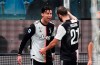 Juventus' Cristiano Ronaldo, left, celebrates with his teammate Gonzalo Higuain after scoring his side's second goal during a Serie A soccer match between Sampdoria and Juventus, at Luigi Ferraris stadium in Genoa, Italy, Wednesday, Dec. 18, 2019. (Luca Zennaro/ANSA via AP)
