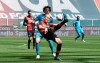 Genoa's Andrea Masiello kicks the ball away from Spezia's Luca Vignali go for the ball during the Serie A soccer match between Genoa and Spezia at the Luigi Ferraris stadium in Genoa, Italy, Saturday, April 24, 2021. (Tano Pecoraro/LaPresse via AP)