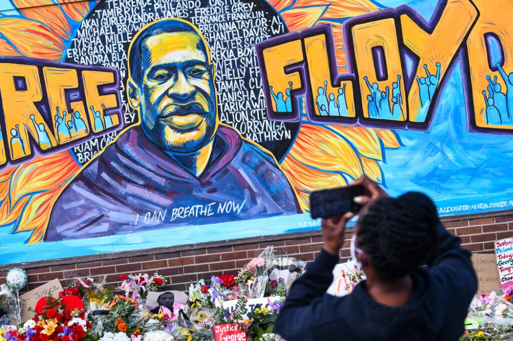 A person photographs a mural in memory of George Floyd in Minneapolis. Floyd died while in Minneapolis police custody and protests have erupted across the United States after video was released showing a Minneapolis Police officer kneeling on his neck while he was handcuffed and pleading that he could not breathe. (Dave Schwarz/St. Cloud Times via AP)