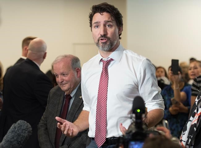 Prime Minister Justin Trudeau speaks to reporters during a visit to a clothing factory in Montreal, Friday, January 31, 2020. THE CANADIAN PRESS/Graham Hughes