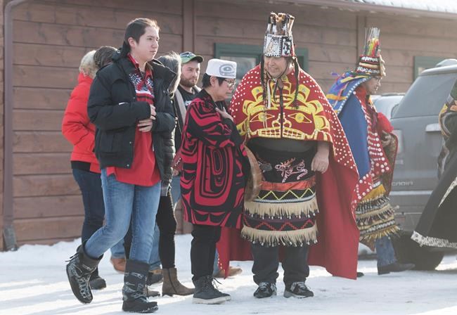 People leave a meeting between Wet'suwet'en hereditary chiefs and Mohawk leaders on the Kahnawake Mohawk Territory south of Montreal, Saturday, February 22, 2020. THE CANADIAN PRESS/Graham Hughes