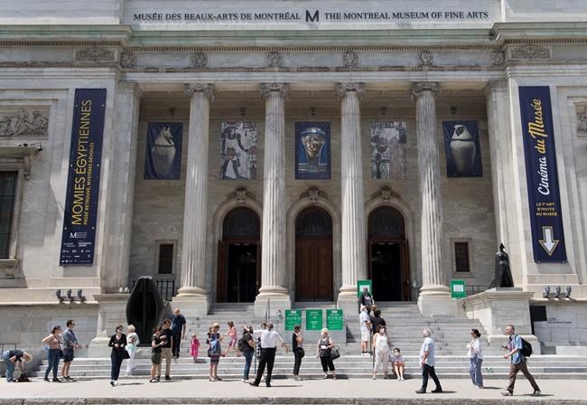 People wear face masks as they wait to enter the Museum of Fine Arts in Montreal, Saturday, June 6, 2020, as the COVID-19 pandemic continues in Canada and around the world. THE CANADIAN PRESS/Graham Hughes