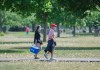 People wear face masks as they walk through a park in Montreal, Saturday, May 30, 2020, as the COVID-19 pandemic continues in Canada and around the world. THE CANADIAN PRESS/Graham Hughes