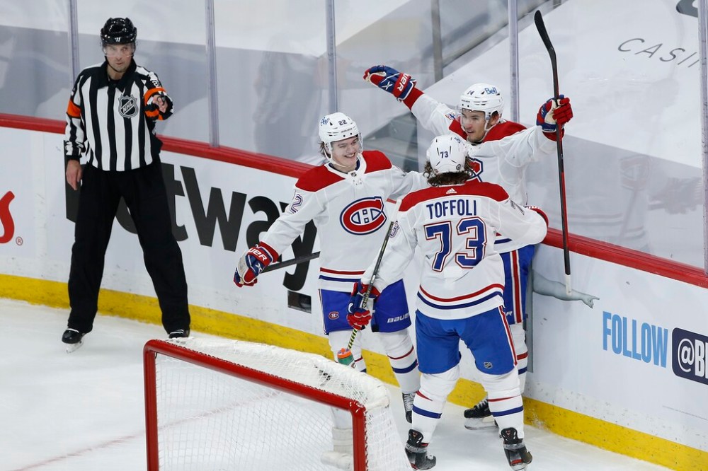 CP
Montreal Canadiens' Nick Suzuki celebrates a goal with teammates Cole Caufield and Tyler Toffoli during the first period Wednesday. THE CANADIAN PRESS