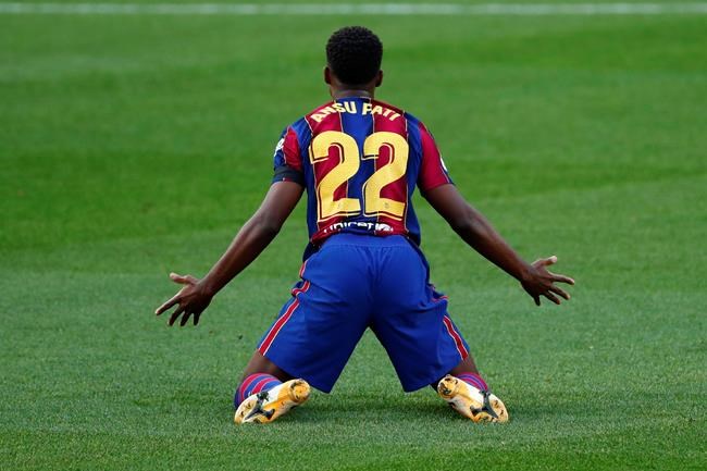 Barcelona's Ansu Fati gestures during the Spanish La Liga soccer match between FC Barcelona and Betis at the Camp Nou stadium in Barcelona, Spain, Saturday, Nov. 7, 2020. (AP Photo/Joan Monfort)