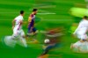 In this photo taken with slow shutter speed, Barcelona's Lionel Messi, second left, runs with the ball during the Spanish La Liga soccer match between FC Barcelona and Valladolid CF at the Camp Nou stadium in Barcelona, Spain, Monday, April 5, 2021. (AP Photo/Joan Monfort)