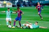 Barcelona's Ansu Fati, second left, is fouled by Betis' Aissa Mandi, bottom who was shown a yellow card for the tackle and a penalty was given during the Spanish La Liga soccer match between FC Barcelona and Betis at the Camp Nou stadium in Barcelona, Spain, Saturday, Nov. 7, 2020. (AP Photo/Joan Monfort)
